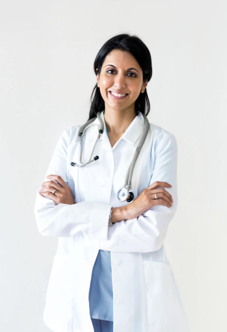 Female doctor smiling with arms crossed and stethoscope around neck.
