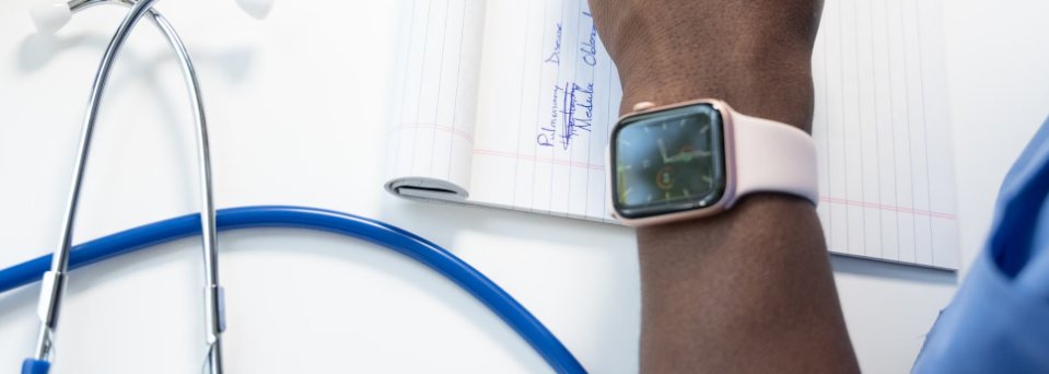 vvrx-service-reporting Medical professional writing notes near stethoscope on a desk.